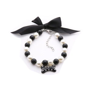 Pet pearl necklace with black bow and rhinestone bone pendant for dogs and cats
