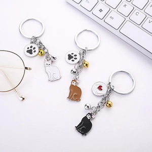 Detail of cat shaped metal keychains with enamel charms and small bells set