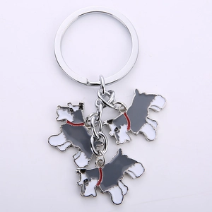 Detailed close-up of three miniature Schnauzer dog pendants with colorful enamel finish