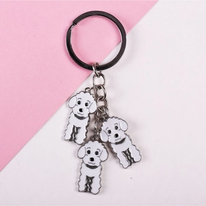 Cute white enamel poodle dog keychain with silver ring on pink and white background