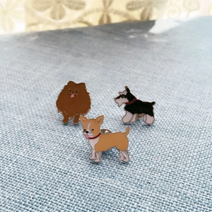 Lot de trois broches en émail représentant des chiens de dessins animés comme le Poméranie