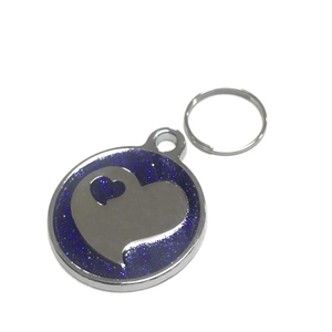 Close-up of heart-patterned blue glitter stainless steel pet tag with round silver ring