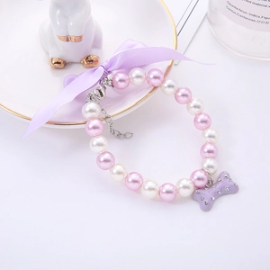 Pink and white pearl pet necklace with purple bow and rhinestone bone pendant