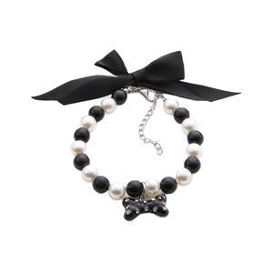 Elegant pet pearl collar with black satin bow and sparkling bone shaped pendant charm