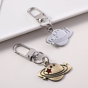Dual planetary galaxy metal keychains in silver and bronze with star details