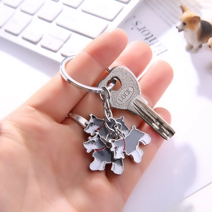 Detail of three Schnauzer dog pendants with enamel finish on a silver metal keychain