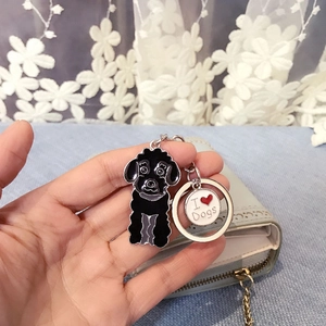 Close-up of black poodle keychain with I Love Dogs metal charm held in hand