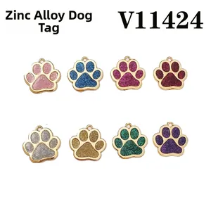Detail of eight glitter zinc alloy paw-shaped dog tags in various colors with gold edges