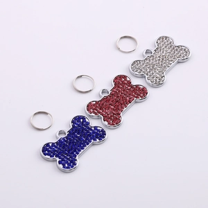 Detail of bone shaped pet ID tags with colorful rhinestones in blue red and white