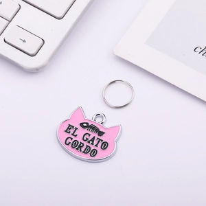 Pink cat-shaped zinc alloy pet ID tag with El Gato Gordo text and fishbone pattern