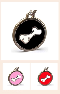Detail of round stainless steel pet tags with bone patterns in black, pink, and red