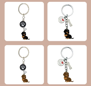 Detail of four dachshund metal keychain styles with enamel dog charms and bone pendants