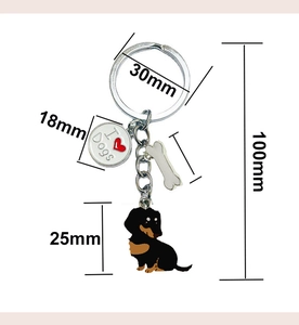 Detailed technical diagram showing dimensions of a metal dachshund dog keychain and bone charm