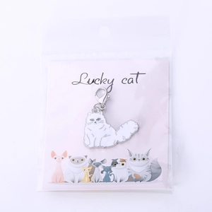 Enamel white cat pendant keychain with silver lobster clasp on Lucky Cat display card