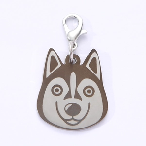 Detailed view of husky shaped stainless steel dog tag with silver lobster clasp and brown accent