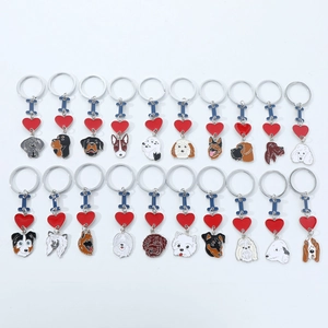 Detailed flat lay of metal dog keychains with colorful enamel breeds and red hearts