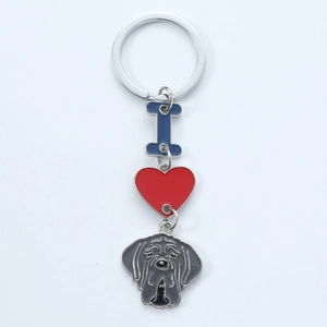Detail of silver heart keychain with bulldog charm and blue letter pendant accessory