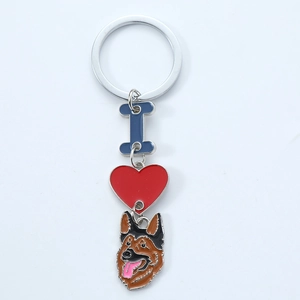 Detail of metal enamel keychain with red heart and German Shepherd dog head charm