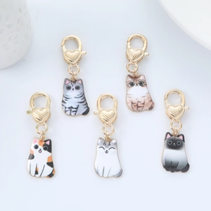 Set of five cartoon cat pendants with golden heart-shaped lobster clasps for bags