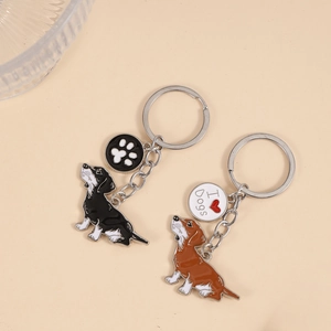 Close-up of black and brown metal dachshund dog keychains with I Love Dogs heart charms
