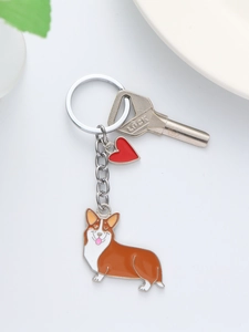 Macro detail of cartoon Corgi dog keychain with red heart charm and silver metal ring