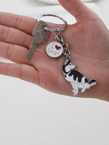 Close-up of husky dog pendant and I Heart Dogs metal charm on a silver keychain