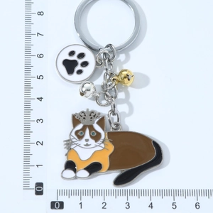 Cartoon crown cat keychain with paw charm and bells, 7.5cm length on white background