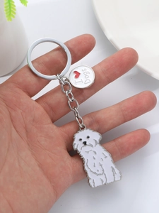 Detail of cute white puppy keychain with silver I Love Dogs charm and metal ring
