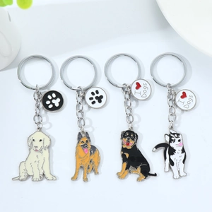 Detail view of 4-piece dog breed enamel keychains including Golden Retriever and Husky