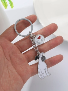 Detail of cute Schnauzer dog keychain with I Heart Dogs charm held in hand