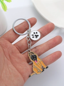 Detail of dog keychain featuring German Shepherd pendant and paw print charm on a metal ring