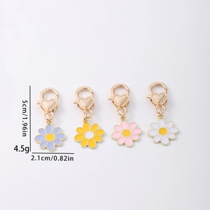 Zinc alloy daisy flower keychains in four colors with gold lobster clasp and heart detail