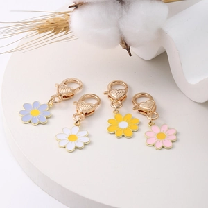 Detailed macro view of colorful zinc alloy daisy pendants with gold heart lobster clasps