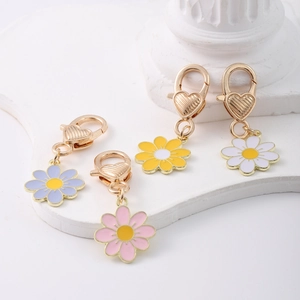 Close-up of four-color flower pendants with heart-shaped golden lobster clasps