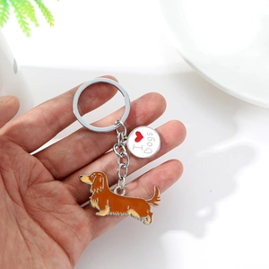 Zinc alloy dachshund keychain featuring an I Love Dogs charm held by a person