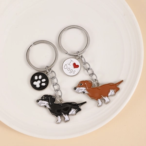 Set of two cute dachshund dog keychains in black and brown with metal heart and paw charms