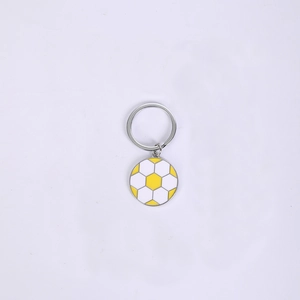 Close-up of zinc alloy round soccer keychain with yellow and white enamel football pattern