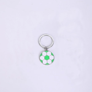 Macro detail of zinc alloy soccer keychain with green and white enamel finish