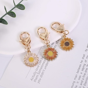 Three colorful enamel sunflower keychain pendants with heart-engraved lobster clasps