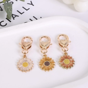 Three-piece set of enamel sunflower keychains with heart-shaped hooks in various colors