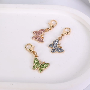 Detail view of zinc alloy butterfly pendants with colorful rhinestones and lobster clasps