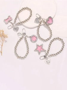 Detailed view of silver beaded pendants featuring heart and star shapes with pink accents