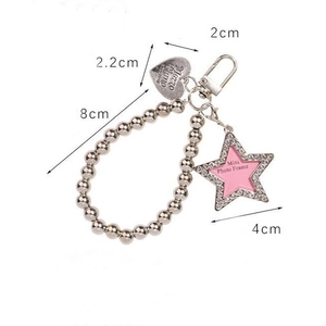 Detail of pink star photo frame pendant with silver bead chain and heart tag