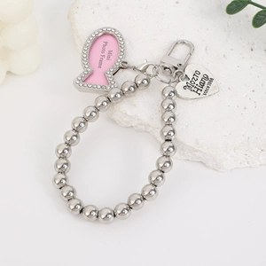 Detail of silver bead chain keychain with heart tag and fish-shaped crystal photo frame