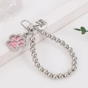 Detail of silver beaded keychain with heart tag and crystal paw-shaped mini photo frame