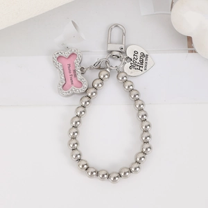 Detail of silver bead chain with pink rhinestone bone frame and engraved heart pendant