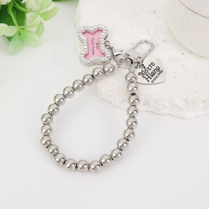 Detail view of silver bead pet charm with pink bone photo frame and engraved heart tag