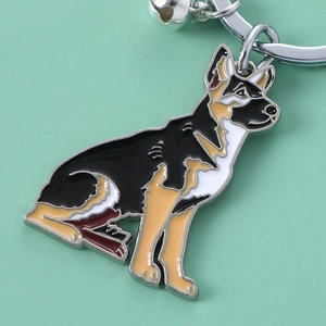 Detailed macro view of enamel German Shepherd keychain with silver bell and ring