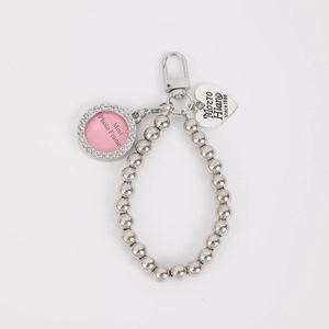 Detailed view of silver bead chain with pink mini photo frame and heart pendant