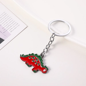 Detailed view of creative red dinosaur keychain with green fins and silver ring